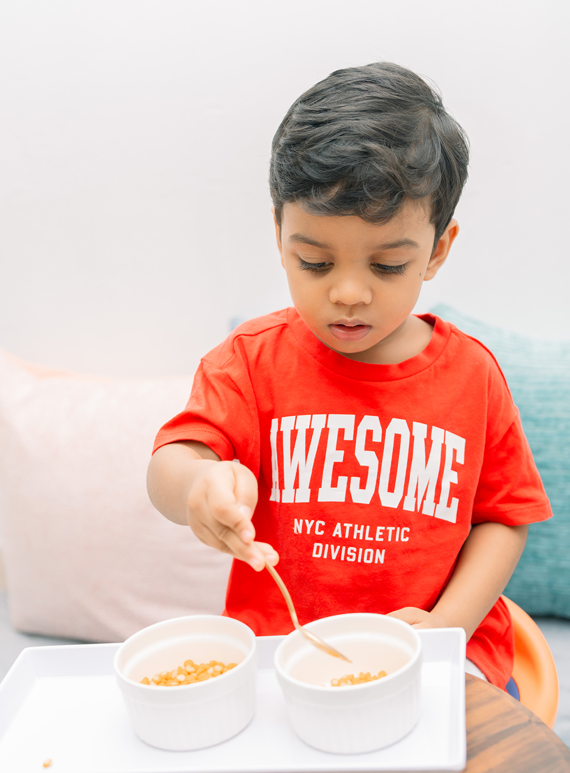 A child absorbed in work with wooden Montessori materials