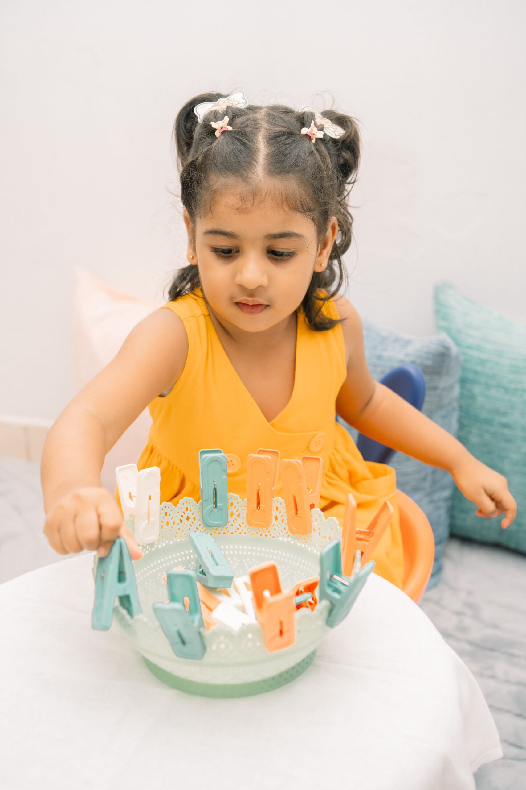 A bright, prepared Montessori classroom with open shelves and wooden materials