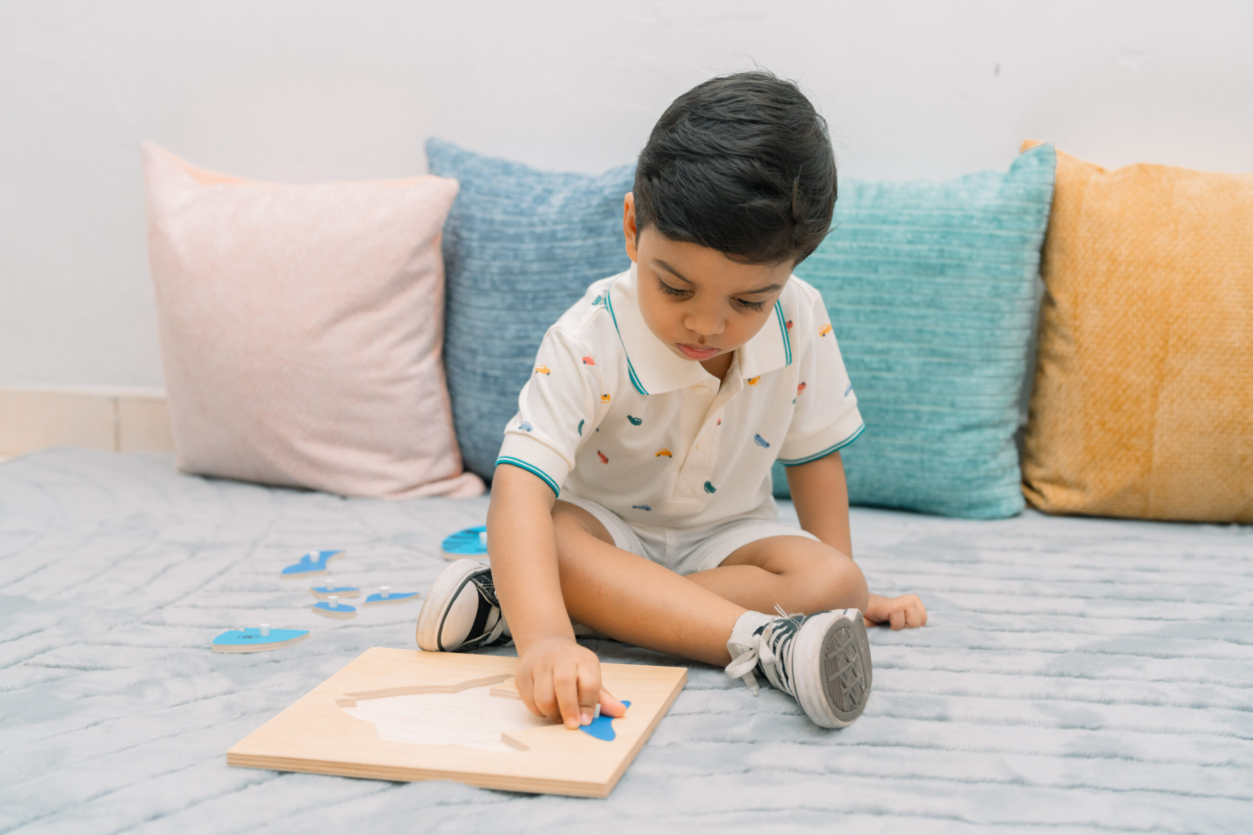 A child building with wooden shapes