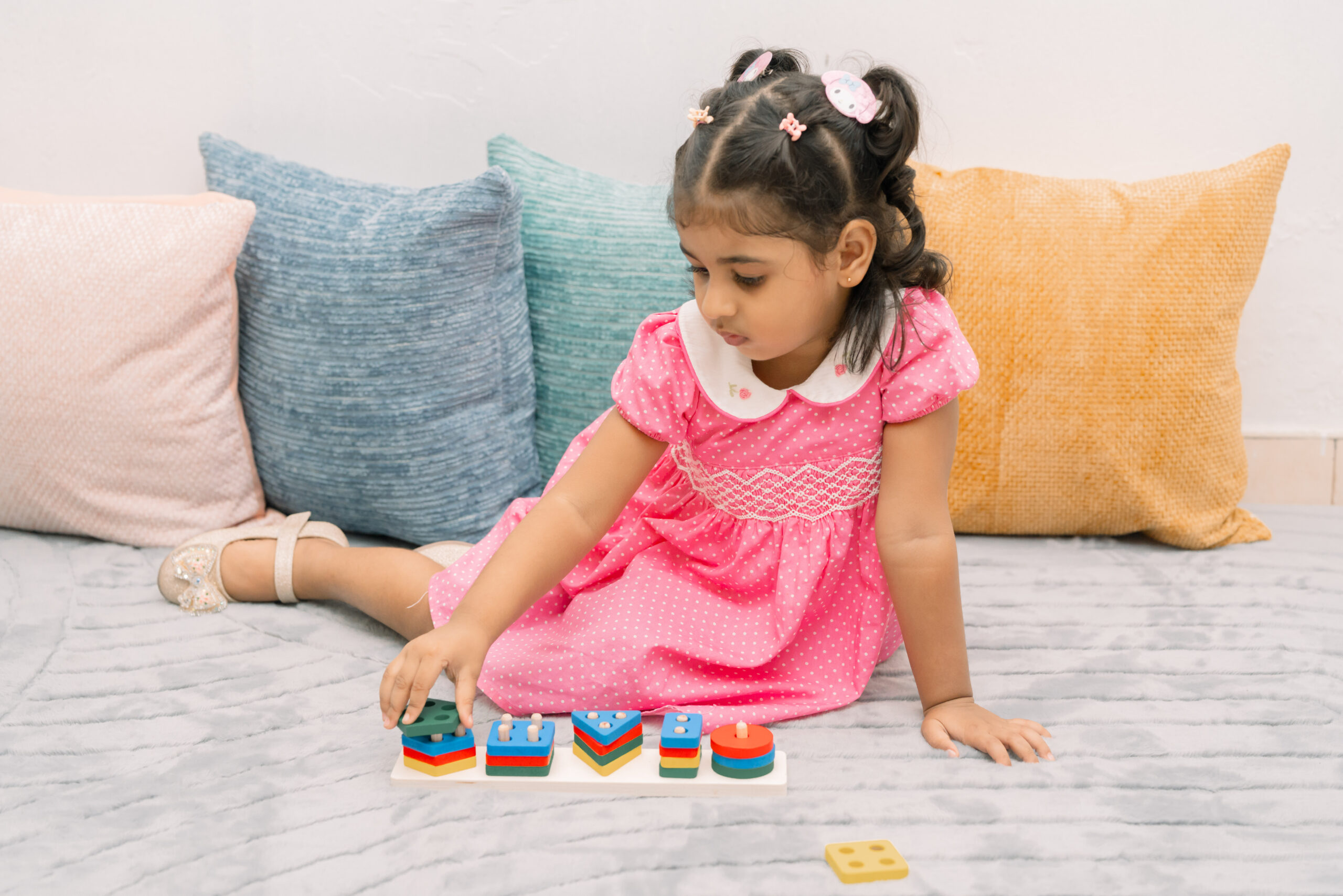 A toddler exploring wooden Montessori blocks