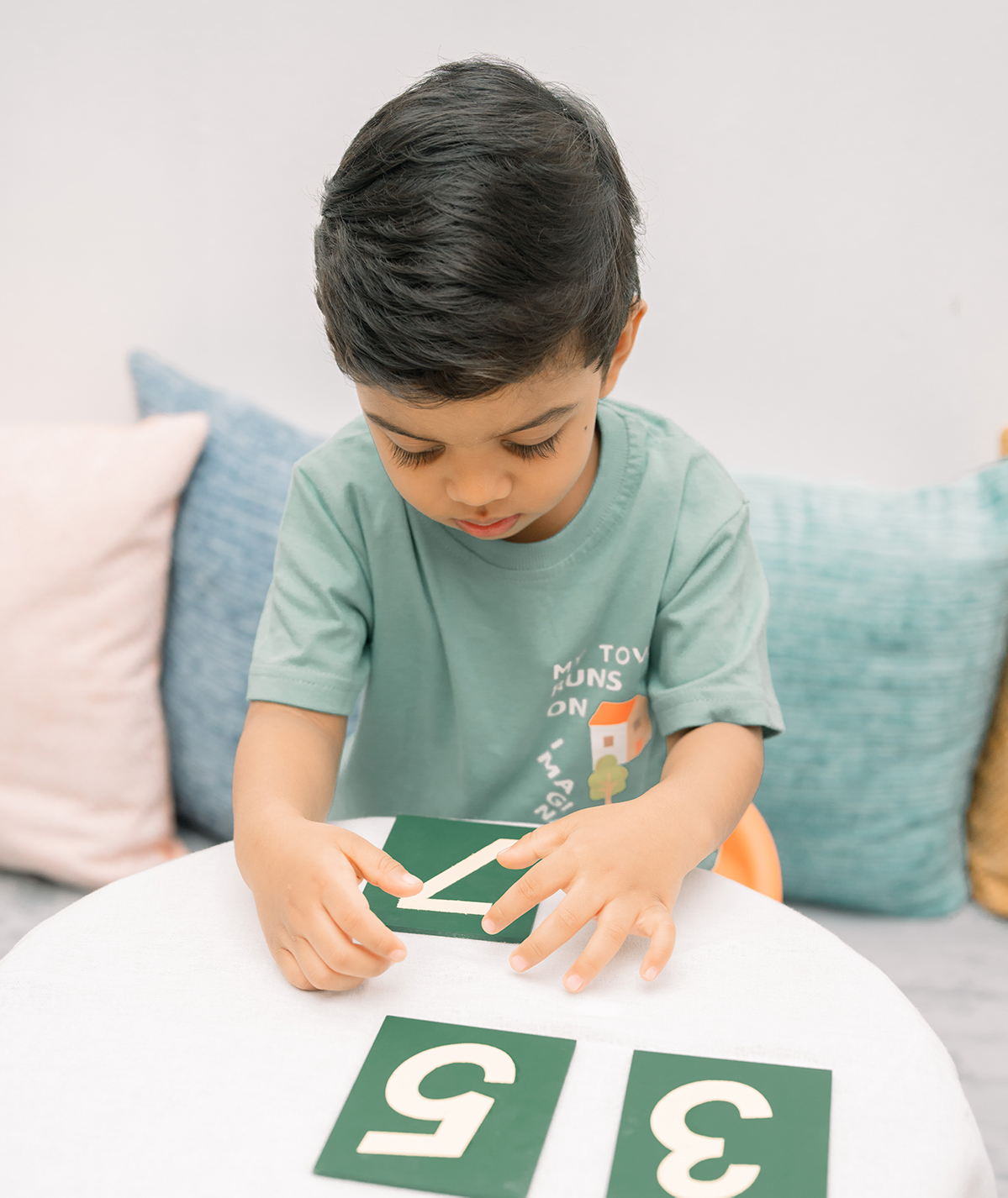 A bright, prepared Montessori classroom with open shelves and wooden materials
