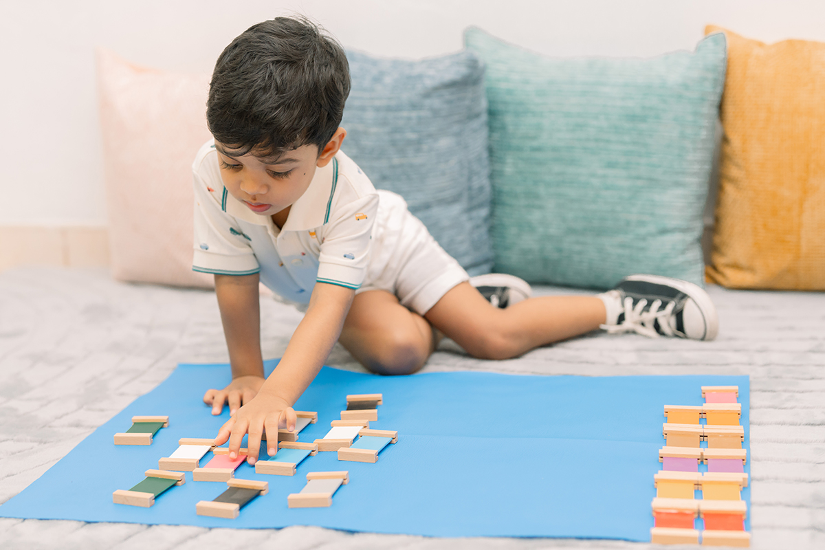 Wooden Montessori materials arranged on an open shelf