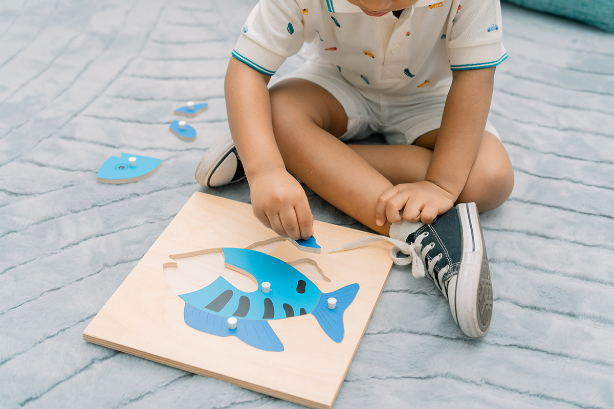 A child working with Montessori learning materials