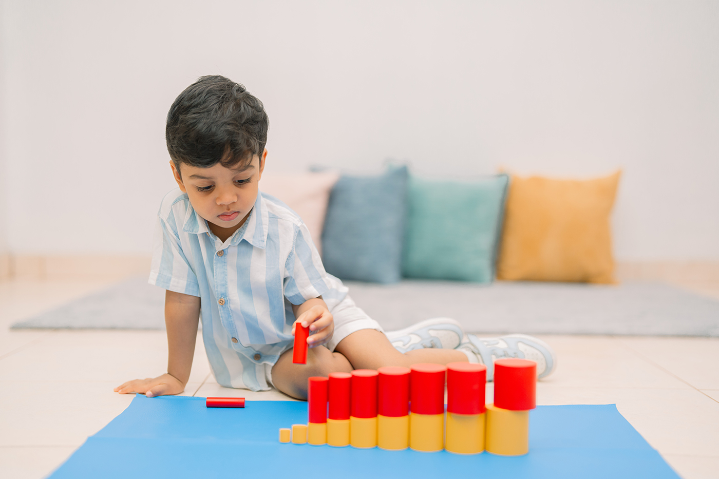 A child concentrating on a counting material
